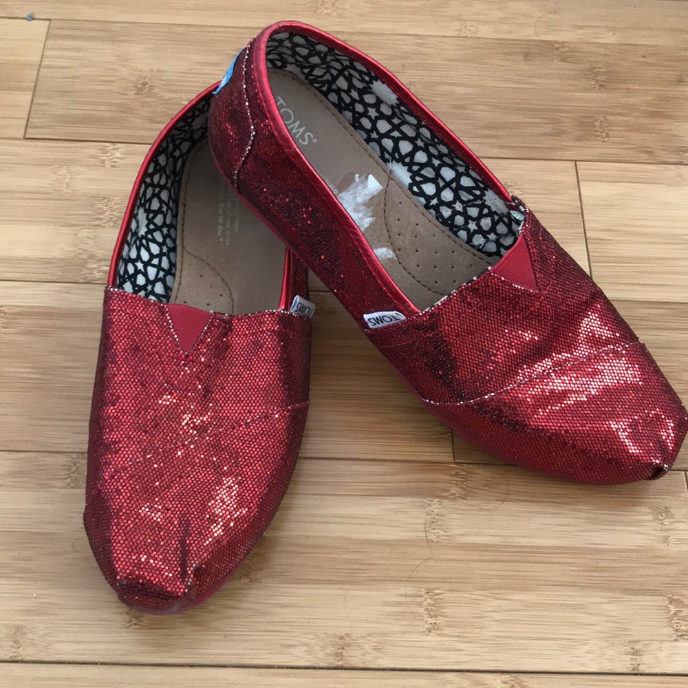 Sparkly ruby red TOMS slip-ons